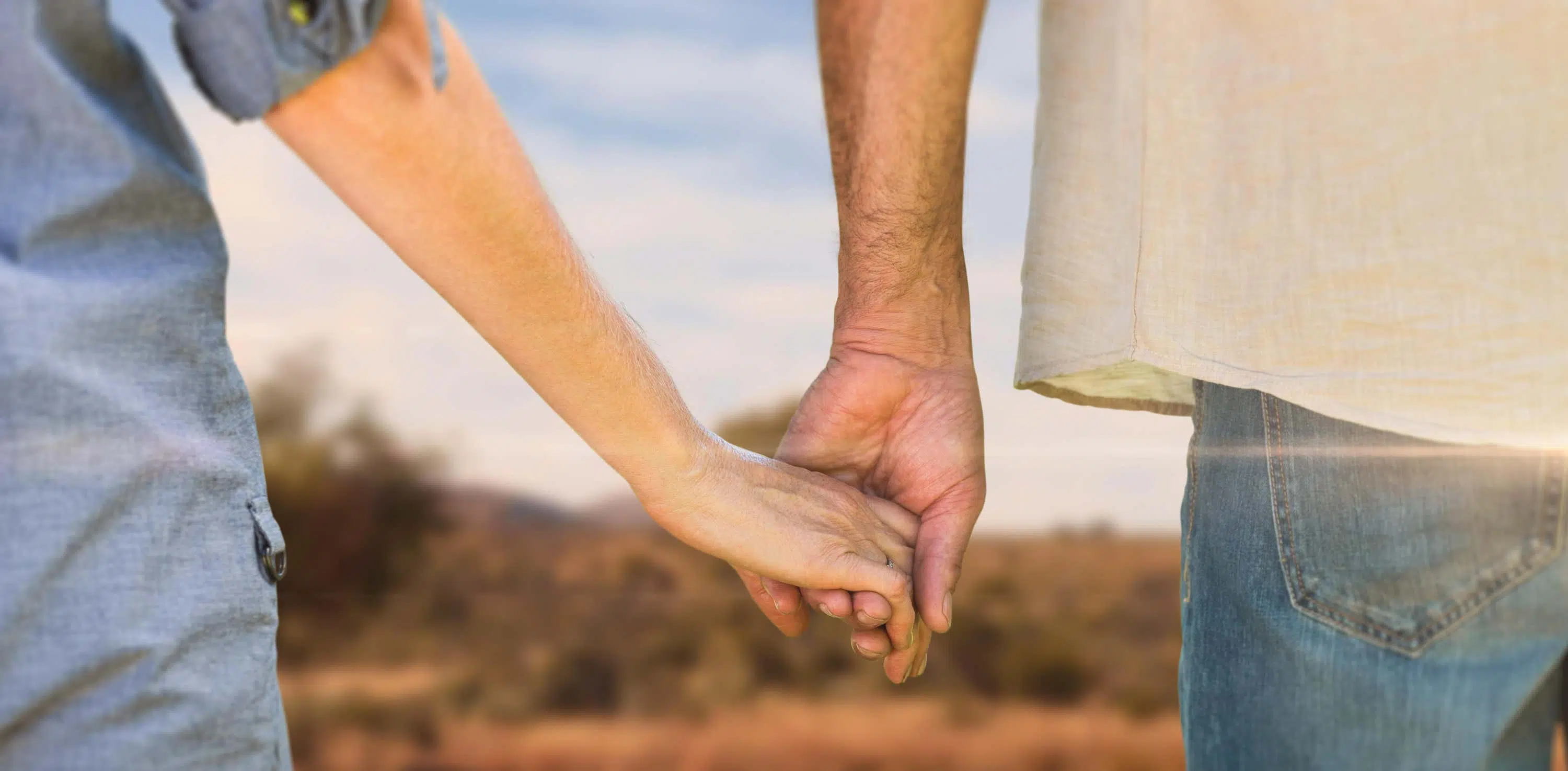 Couple hold hands scaled