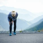 fit person holds knee in pain