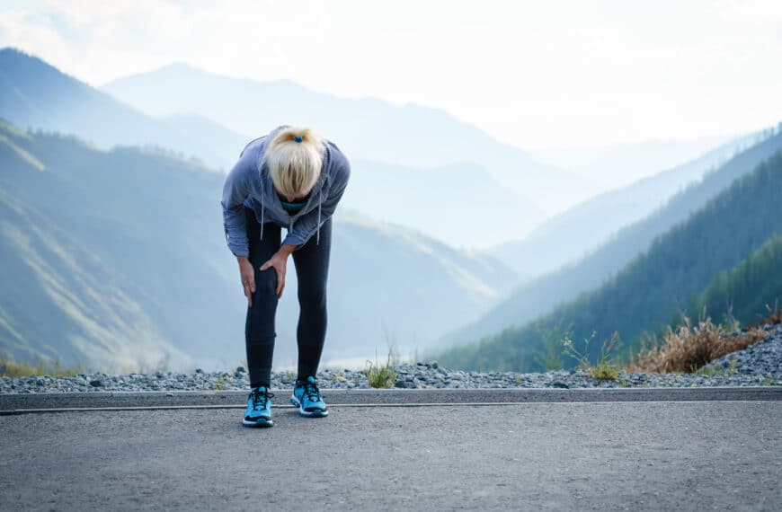 fit person holds knee in pain