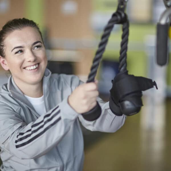 fit woman on pulldown ropes