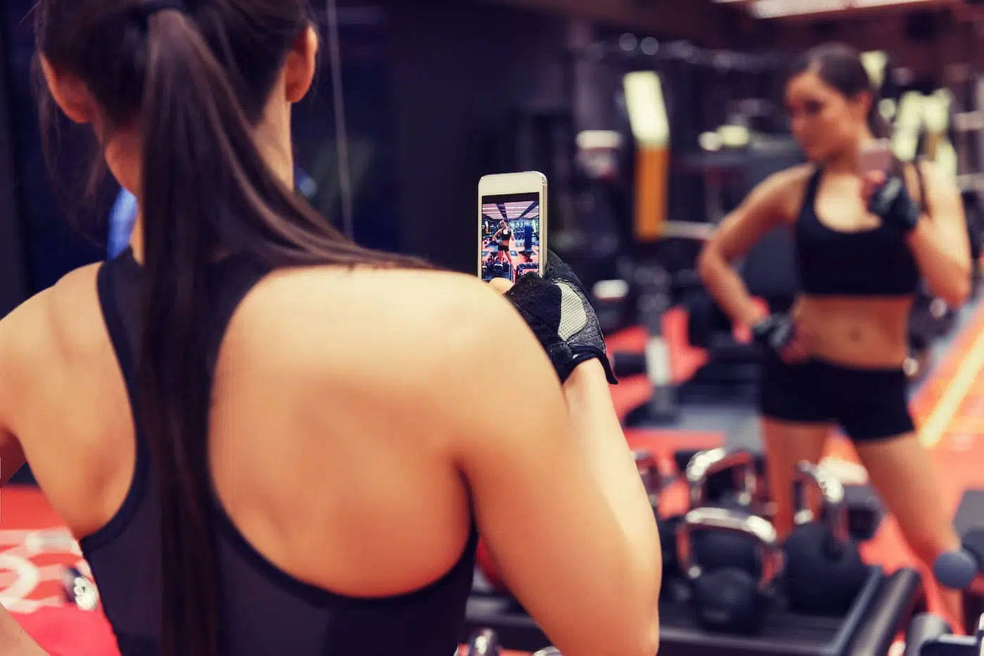 Fitness infuencer takes photo in mirror