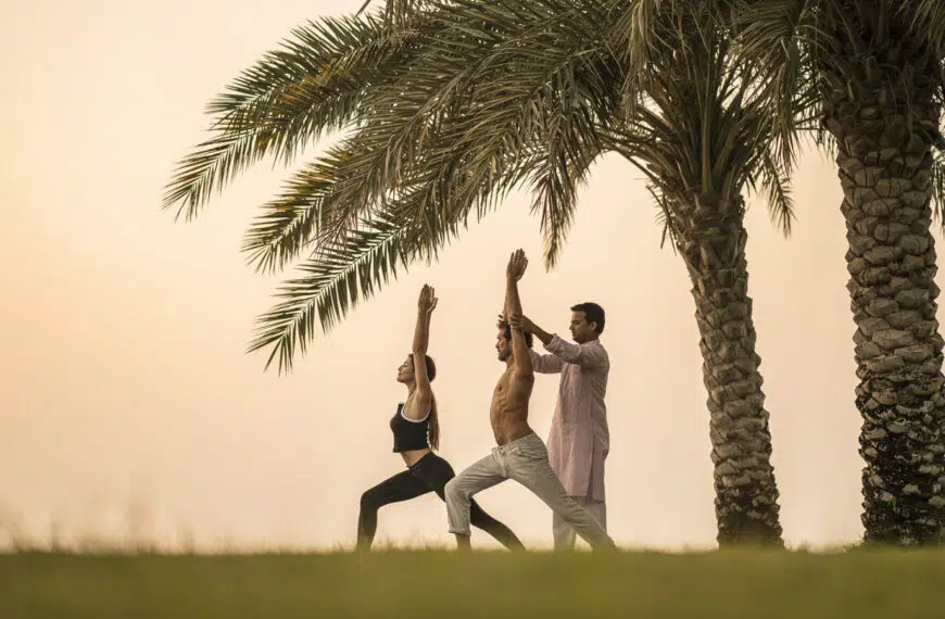 people practice yoga under a tree in bahrain bay