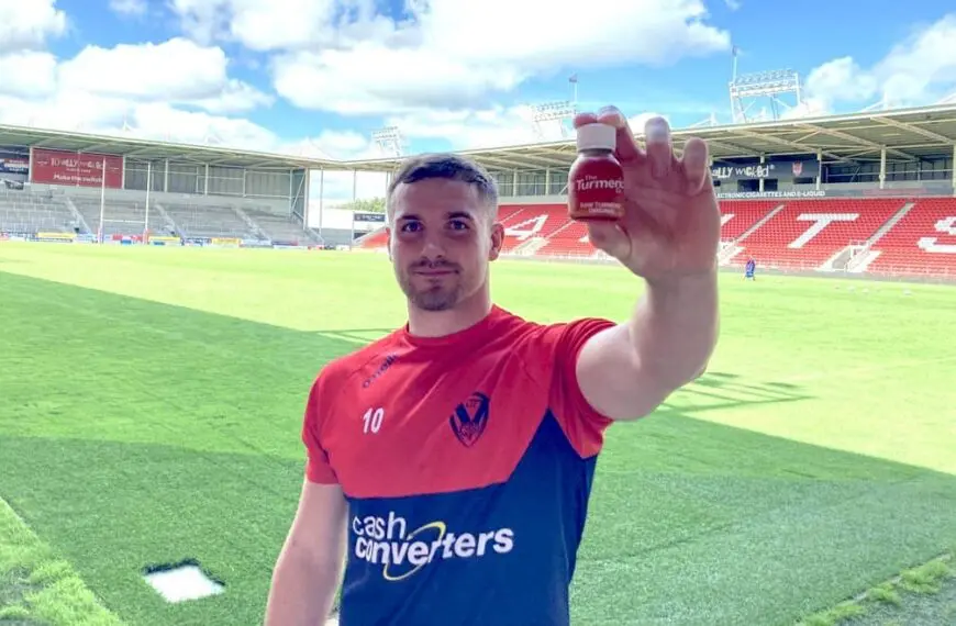 saints player holds up bottle of turmeric co