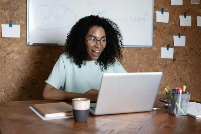 smiling woman at laptop scaled