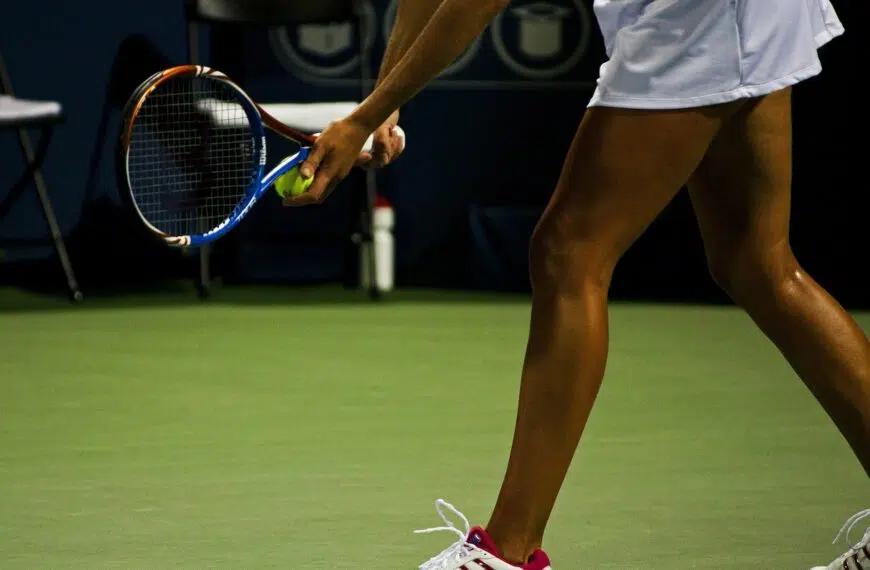 tennis player lines up serve