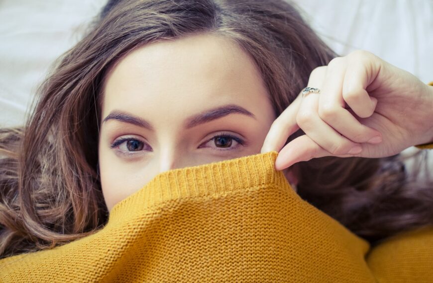 woman hides underneath jumper