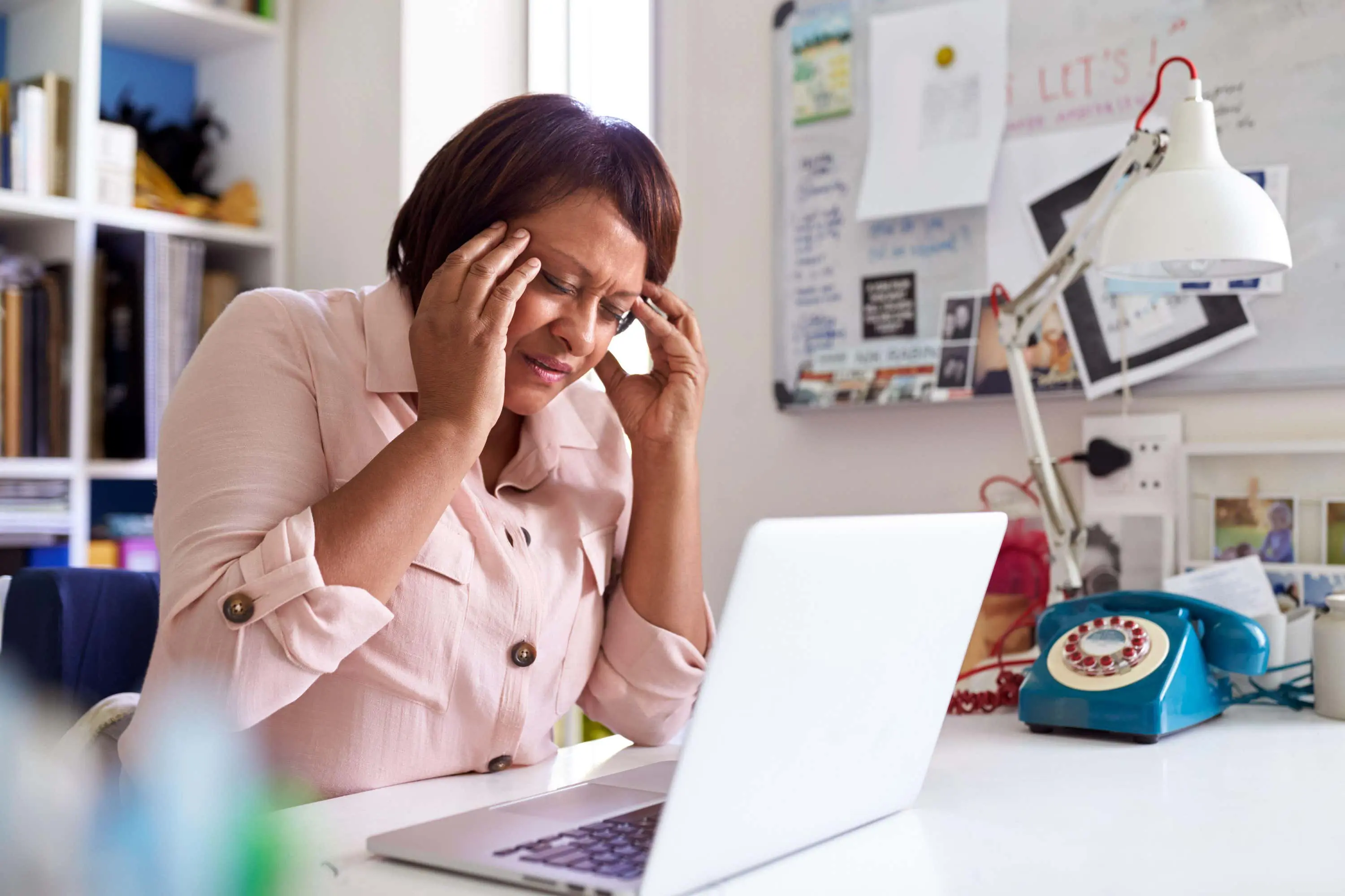 Woman holds head in sadness scaled