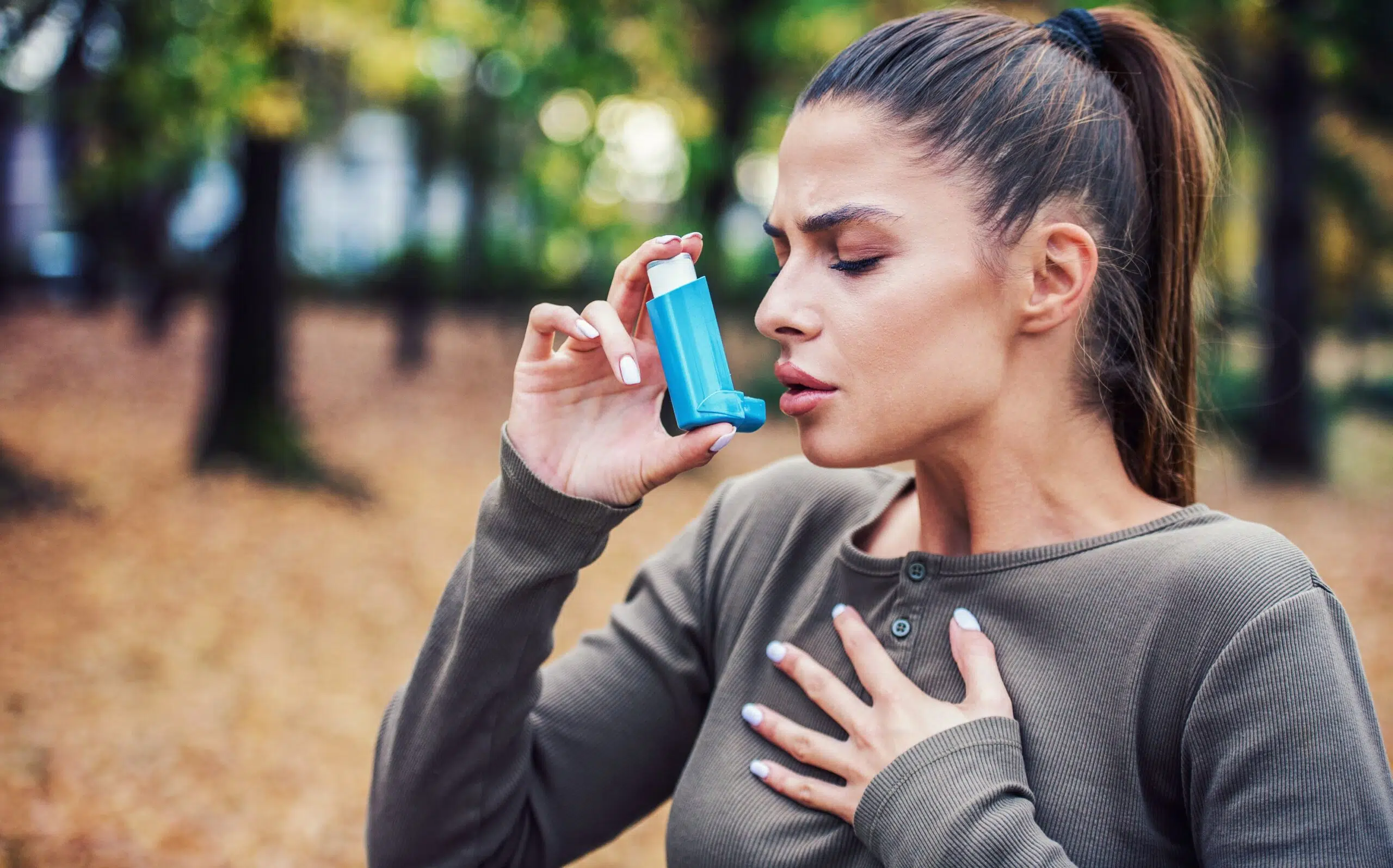 Woman using inhaler scaled