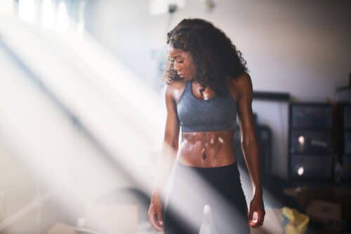 young fit woman stands in position scaled