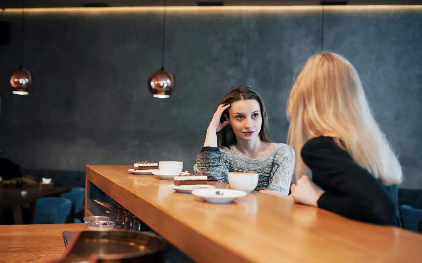 Women talk over a coffee scaled e1629561853315