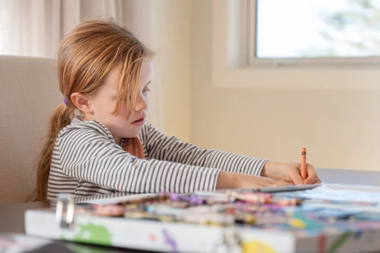 child writes with pencil scaled