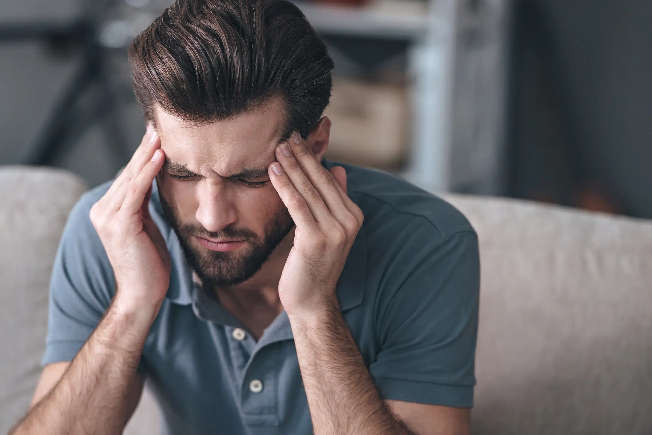 Man holds head in pain with headache
