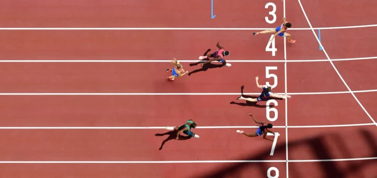 olympic runners cross the finish line