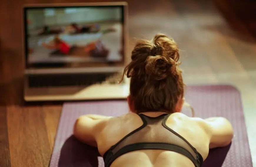 sports woman using online fitness training program in laptop
