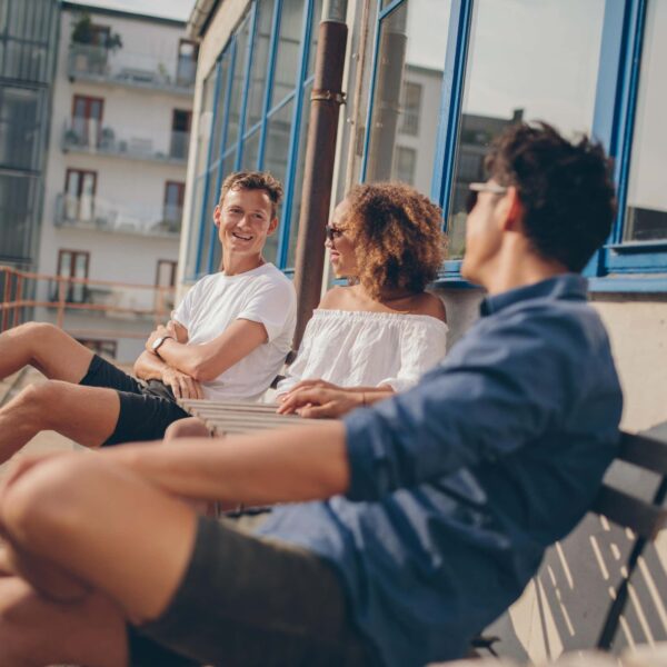 young people on bench share a joke scaled