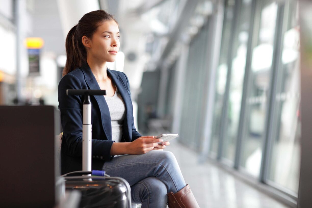 young woman sits at airport