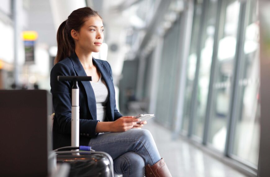 young woman sits at airport