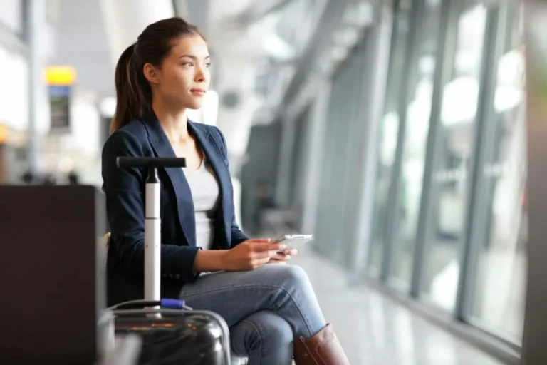 young woman sits at airport