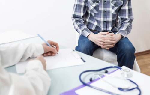 A male patient consults with a doctor about prostate cancer or some other disease.