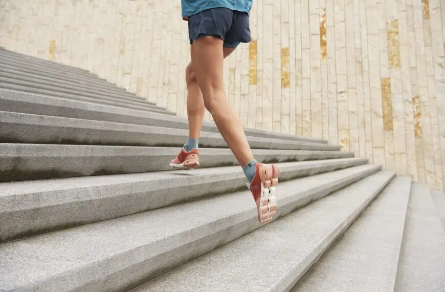 athlete in on running shoes runs up steps scaled