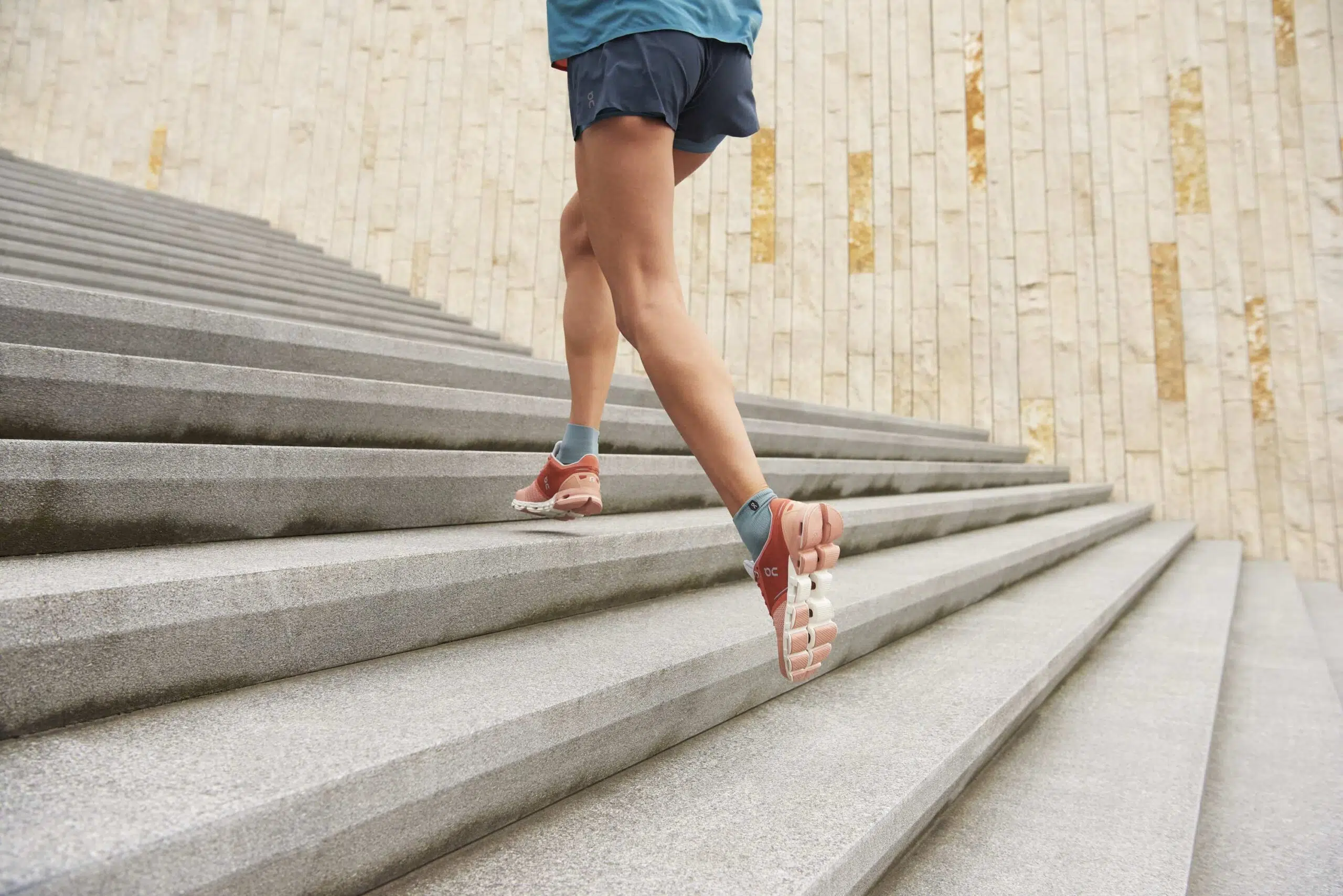 Athlete in on running shoes runs up steps scaled