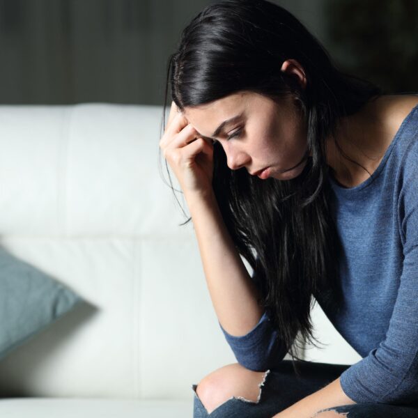 woman hangs head down in sadness scaled