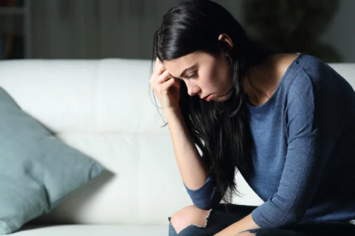 woman hangs head down in sadness scaled