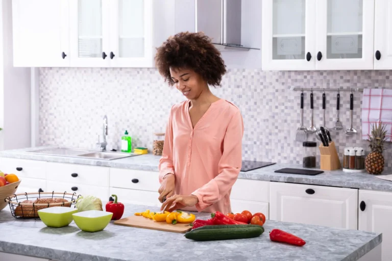 woman in kitchen prepares food scaled