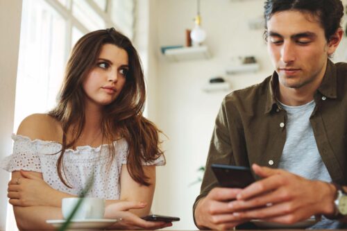 woman looks at man sternly scaled