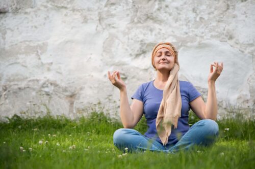 woman practices yoga outside scaled