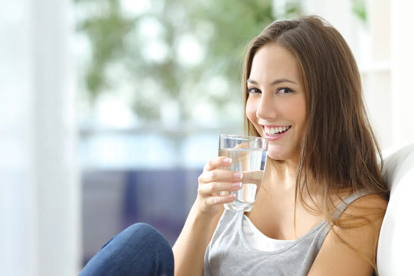 Woman smiles drinking water