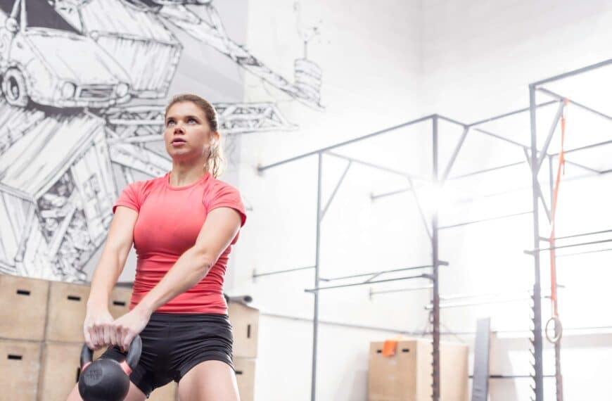 woman swinging kettlebell scaled
