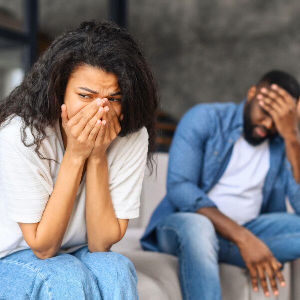 couple hold hands to head in despair scaled