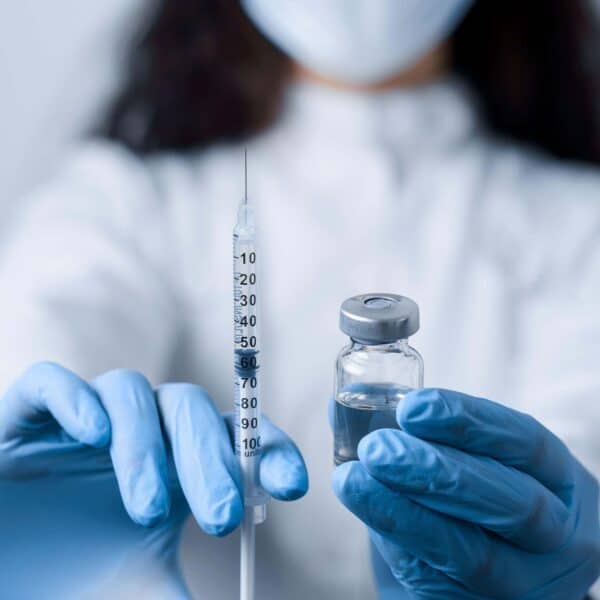 dr holds covid vaccine scaled