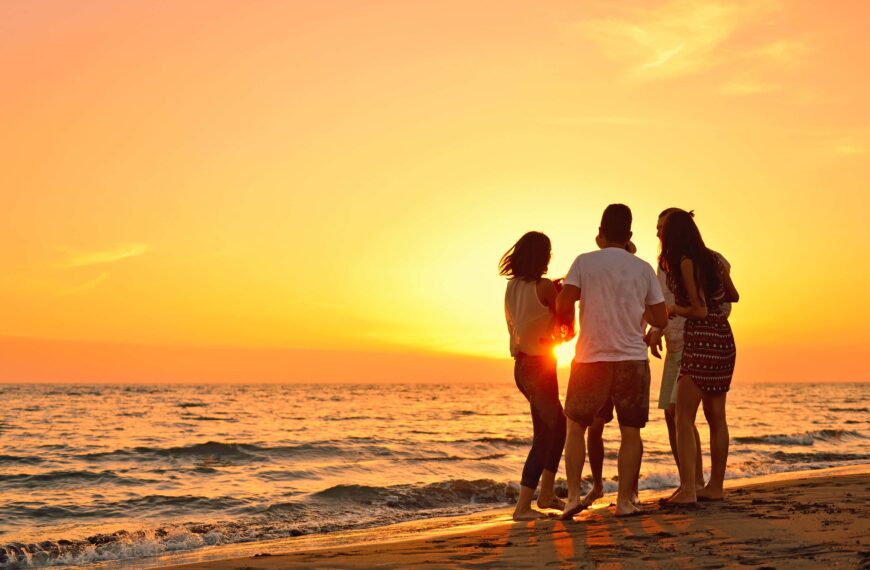 people on a beach during sunset