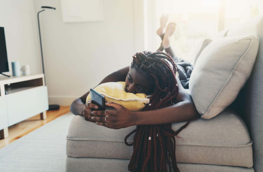 woman lays on bed scaled