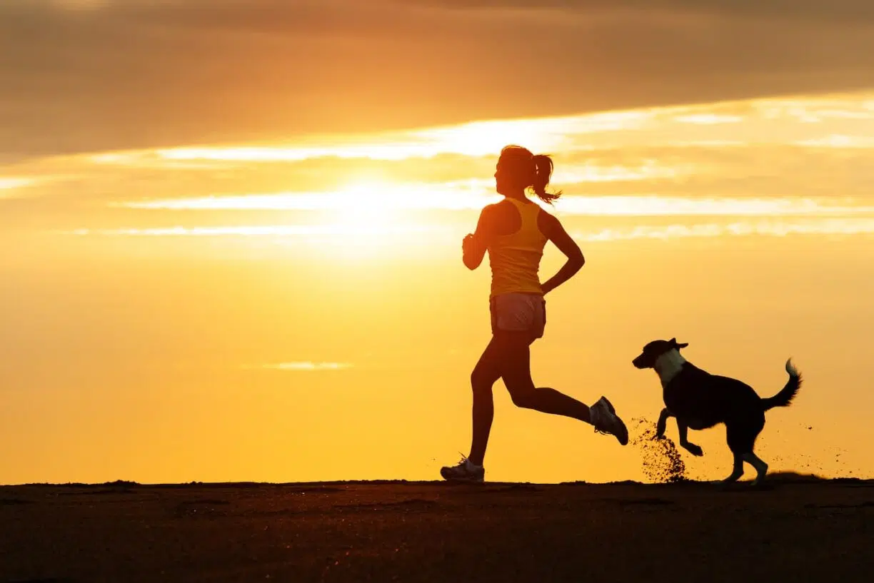 Woman runs with dog