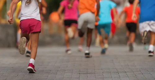 young athletes run in a kids run race running in the city