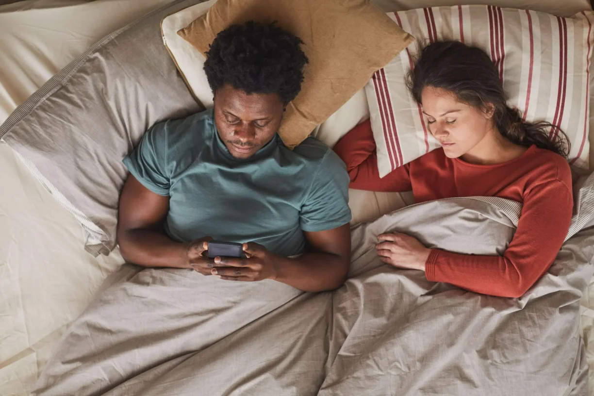 couple laying in bed not sleeping