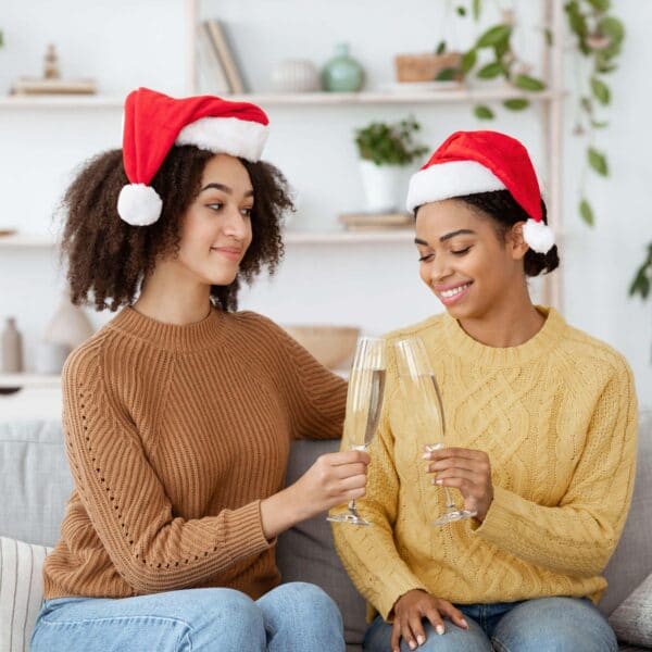 couple wearing santa hats scaled