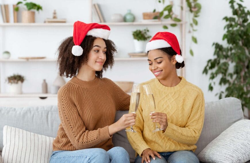 couple wearing santa hats scaled