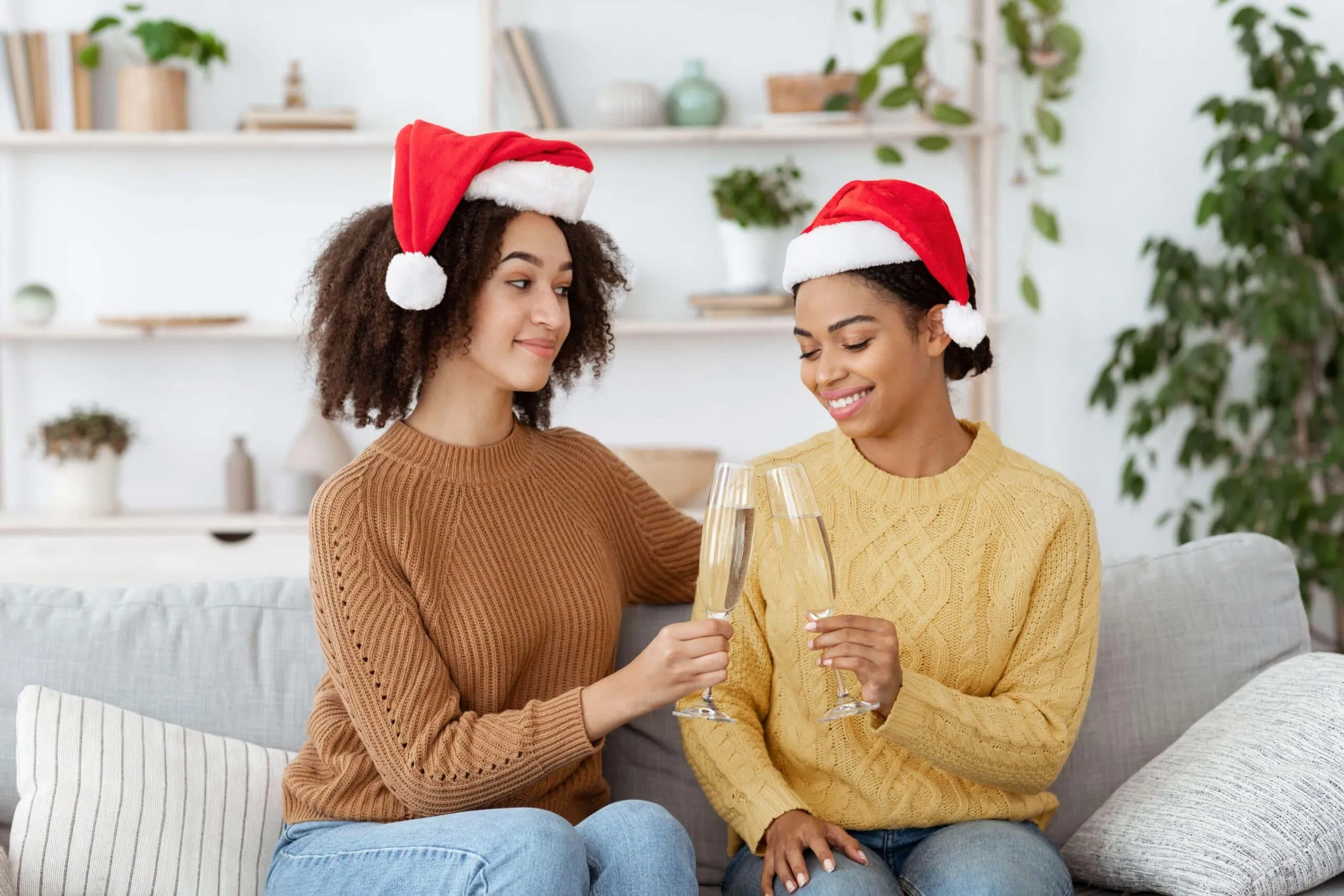 couple wearing santa hats scaled