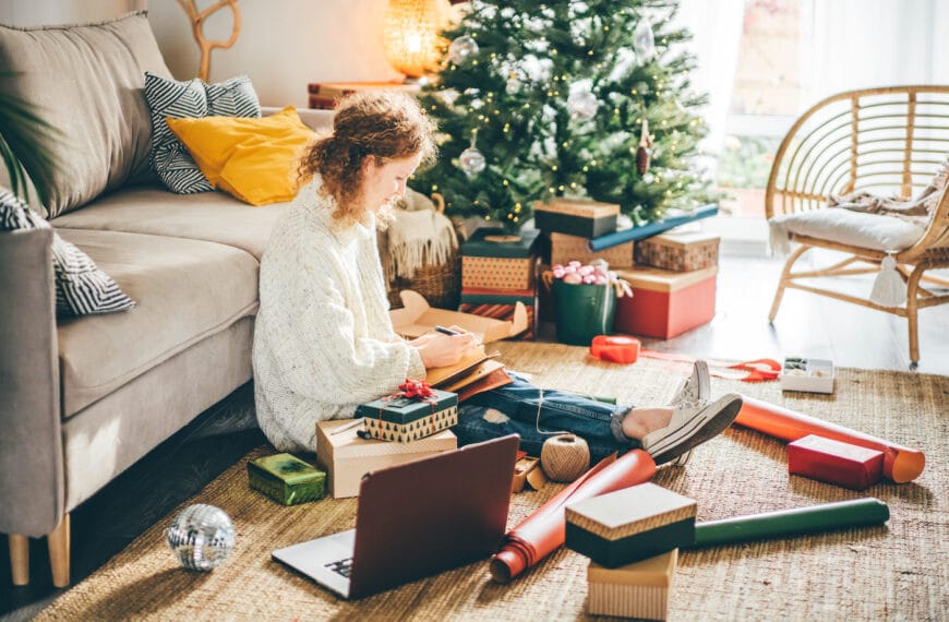 Woman making to do list on 2022 year at notebook.