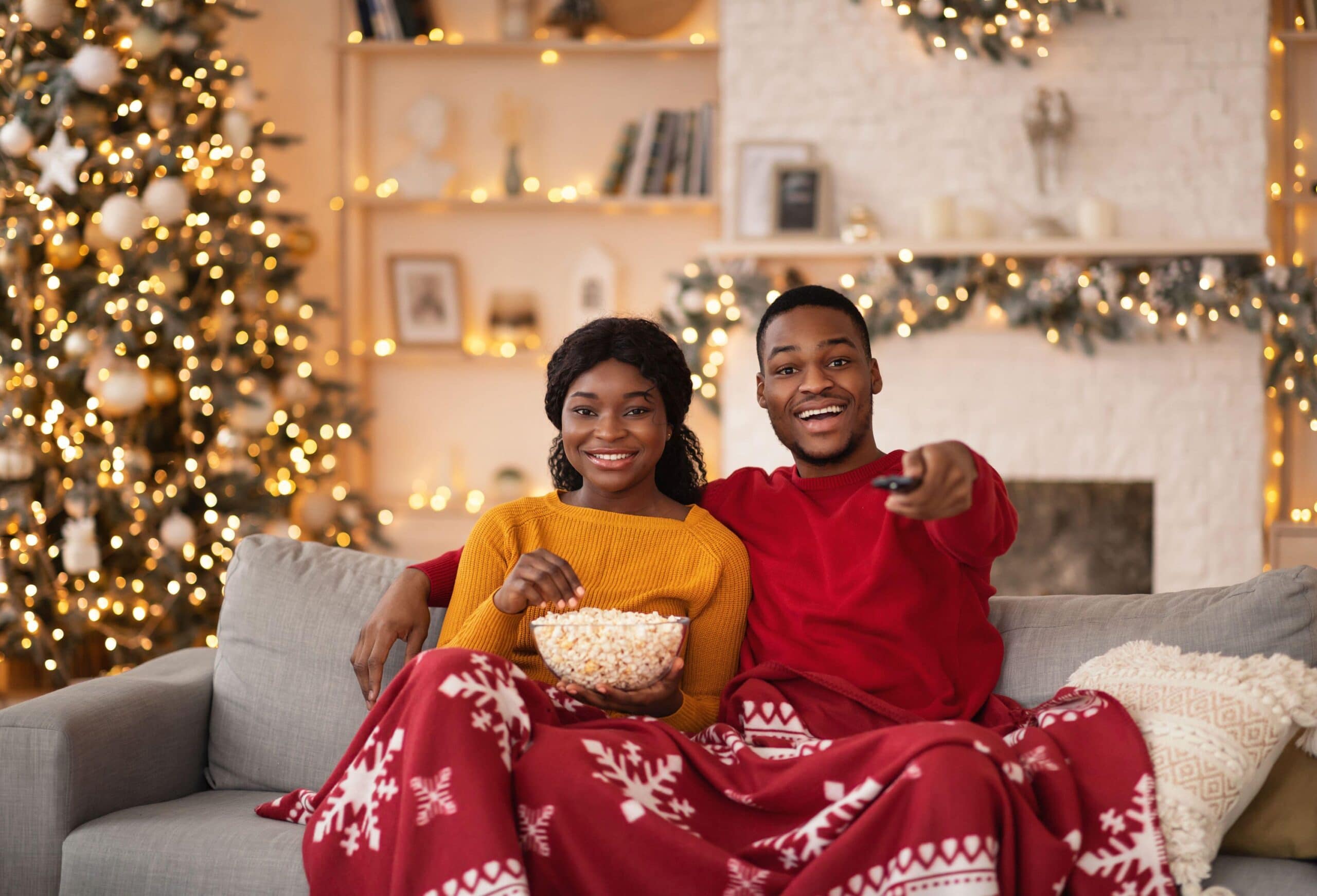 couple laugh wearing christmas pyjamas scaled