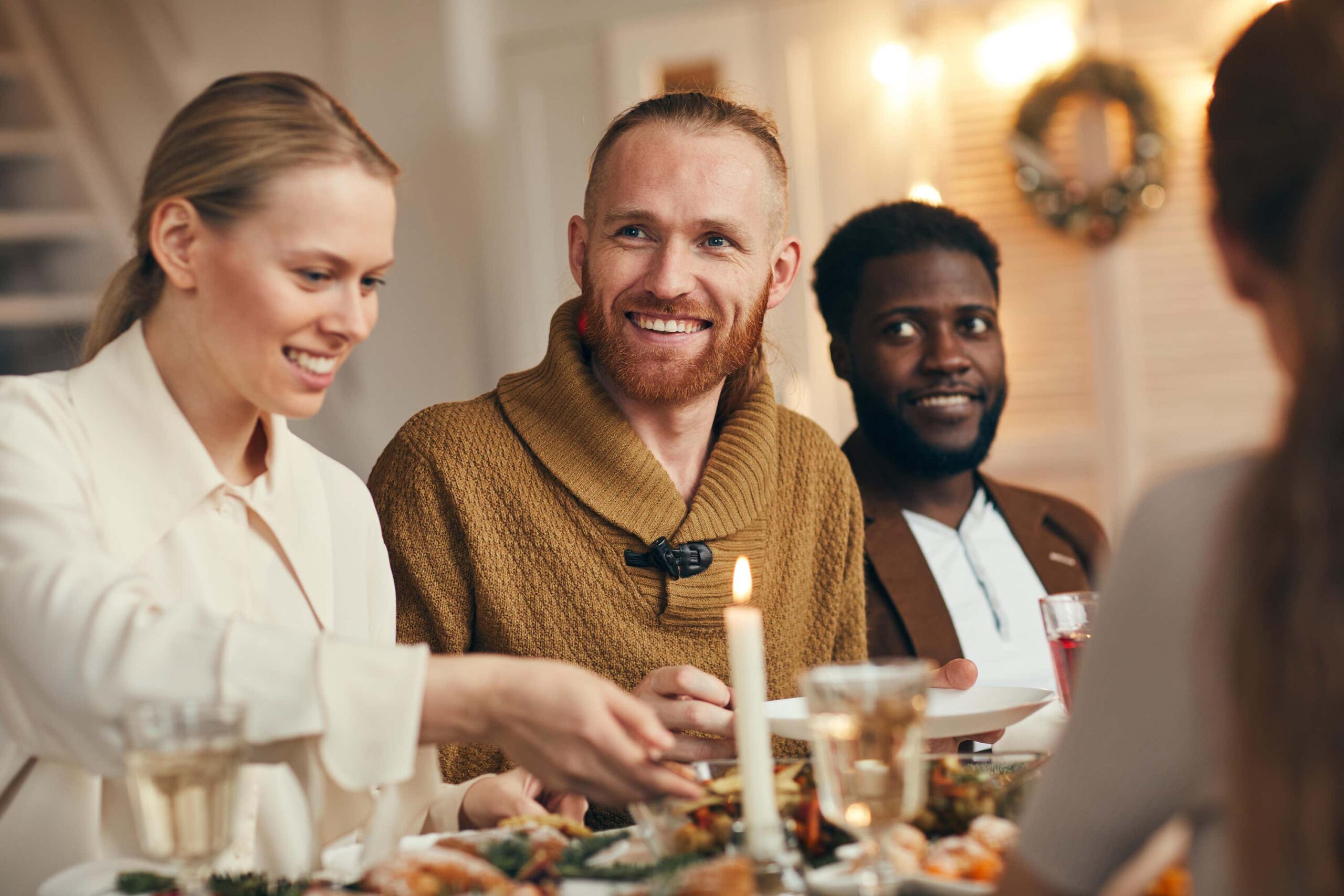 friends laugh and joke over dinner scaled