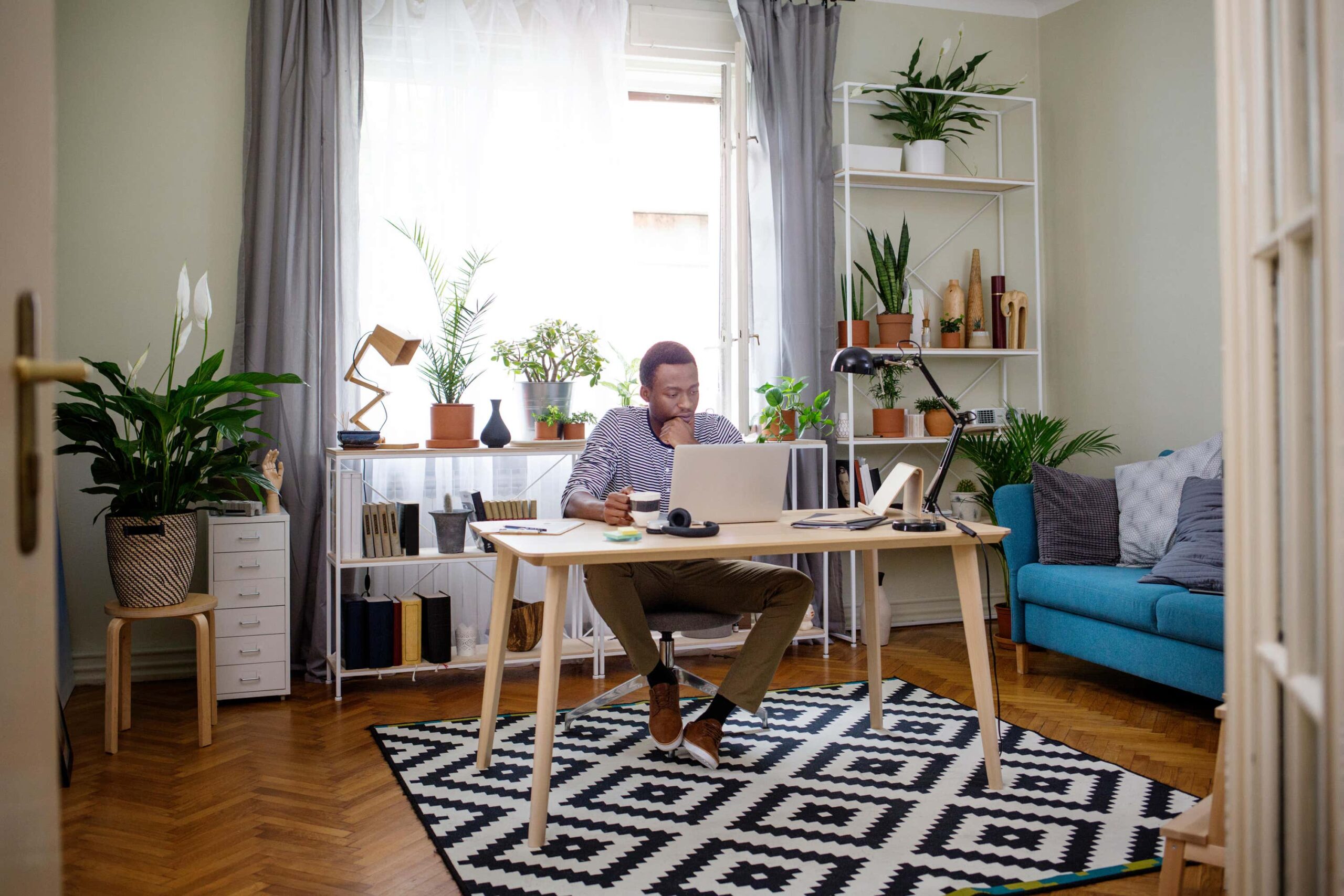 man works from home at table scaled