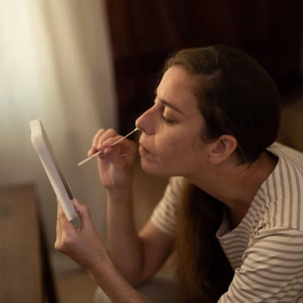 person performs covid test onself