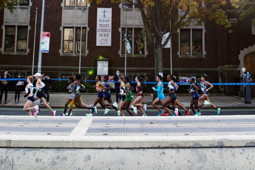 runners race along roadside