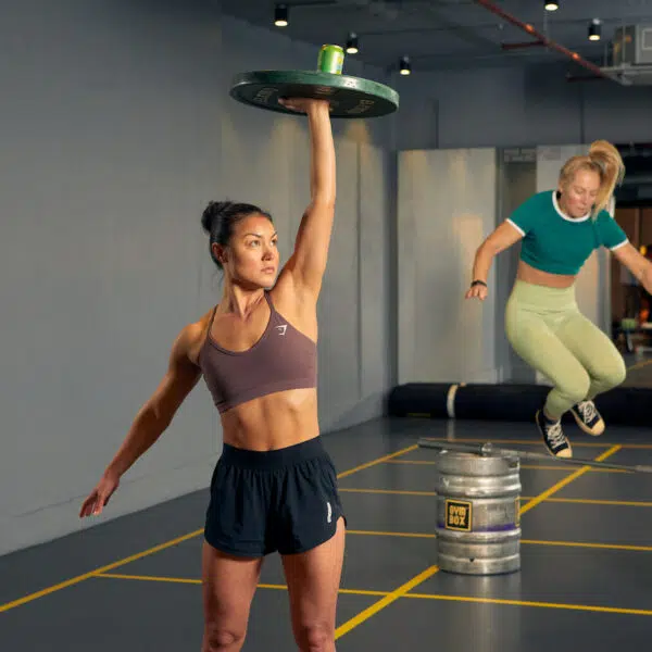 Gymbox trainer lifts weight above head