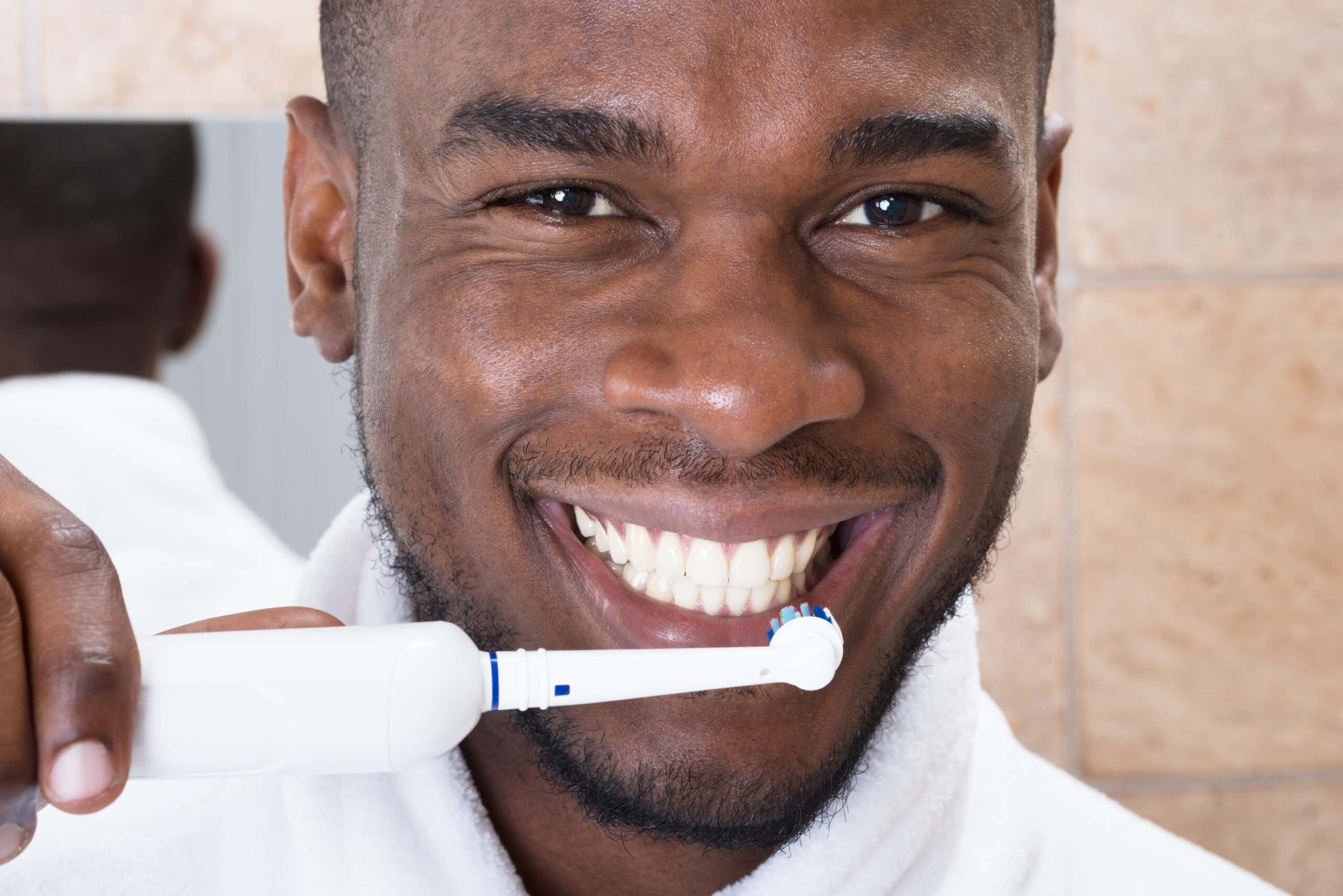 man brushes teeth scaled